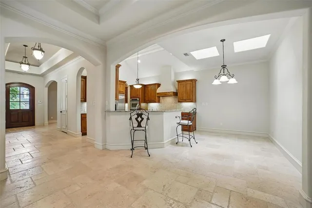 an empty room with fan and windows