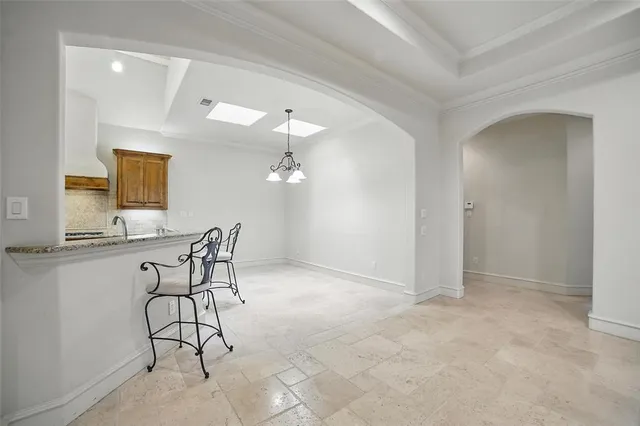 an empty room with fan and entrance