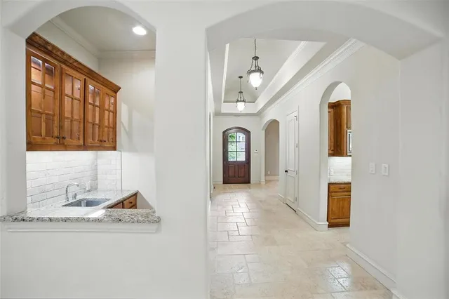an empty room with windows and fireplace