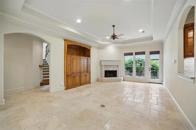 a view of an empty room with window and cabinet