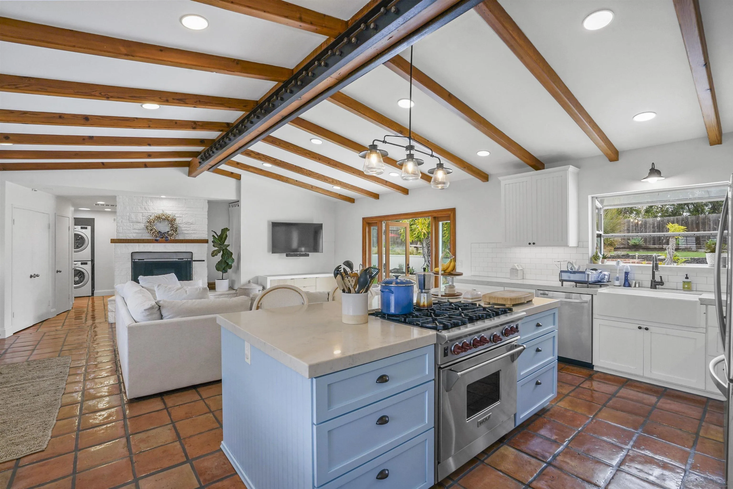 a kitchen with a stove a sink and a refrigerator