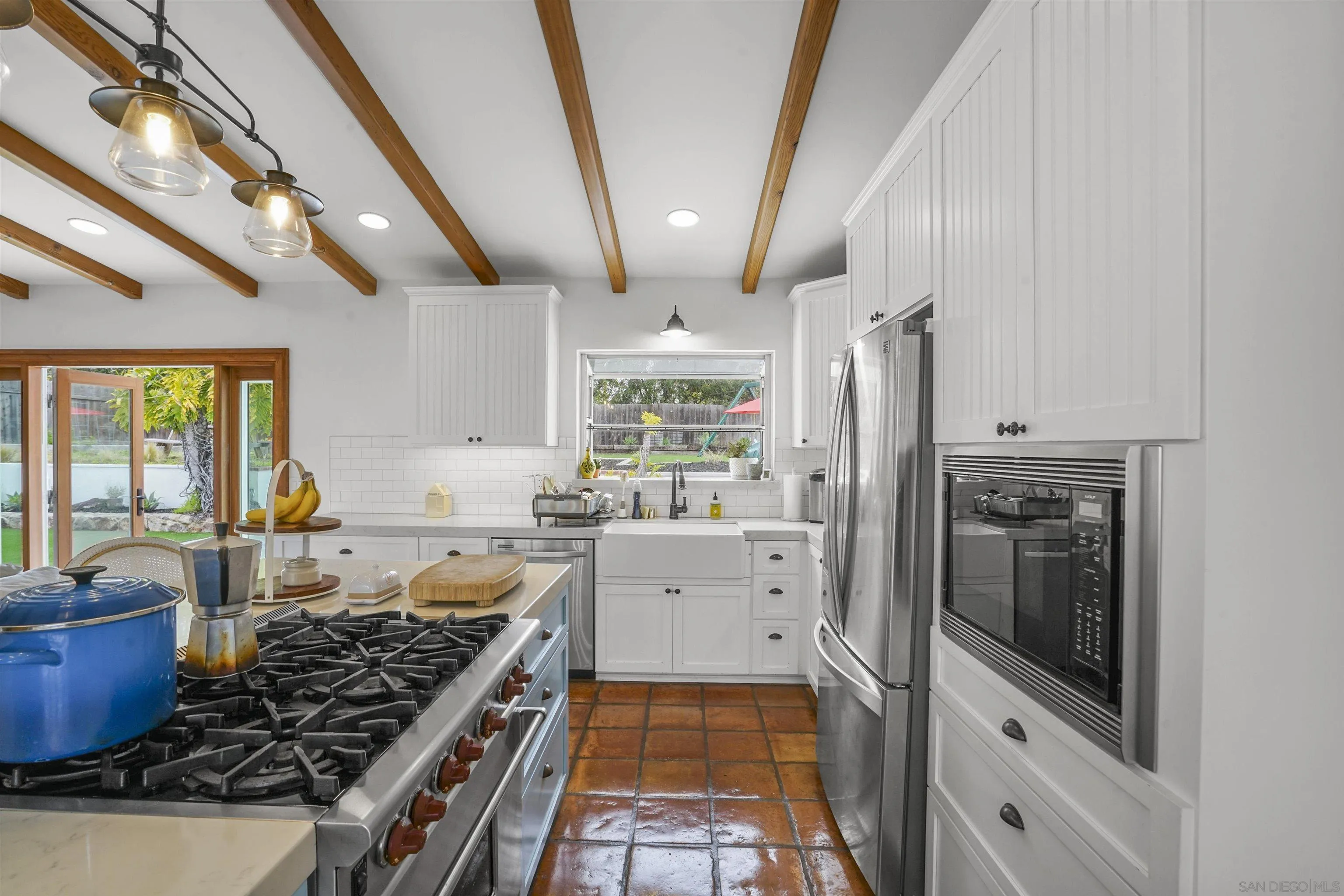 1235 Blue Sky Drive Cardiff, CA 92007 - Photo 14 of 35 a kitchen with stainless steel appliances granite countertop a stove a refrigerator and a sink