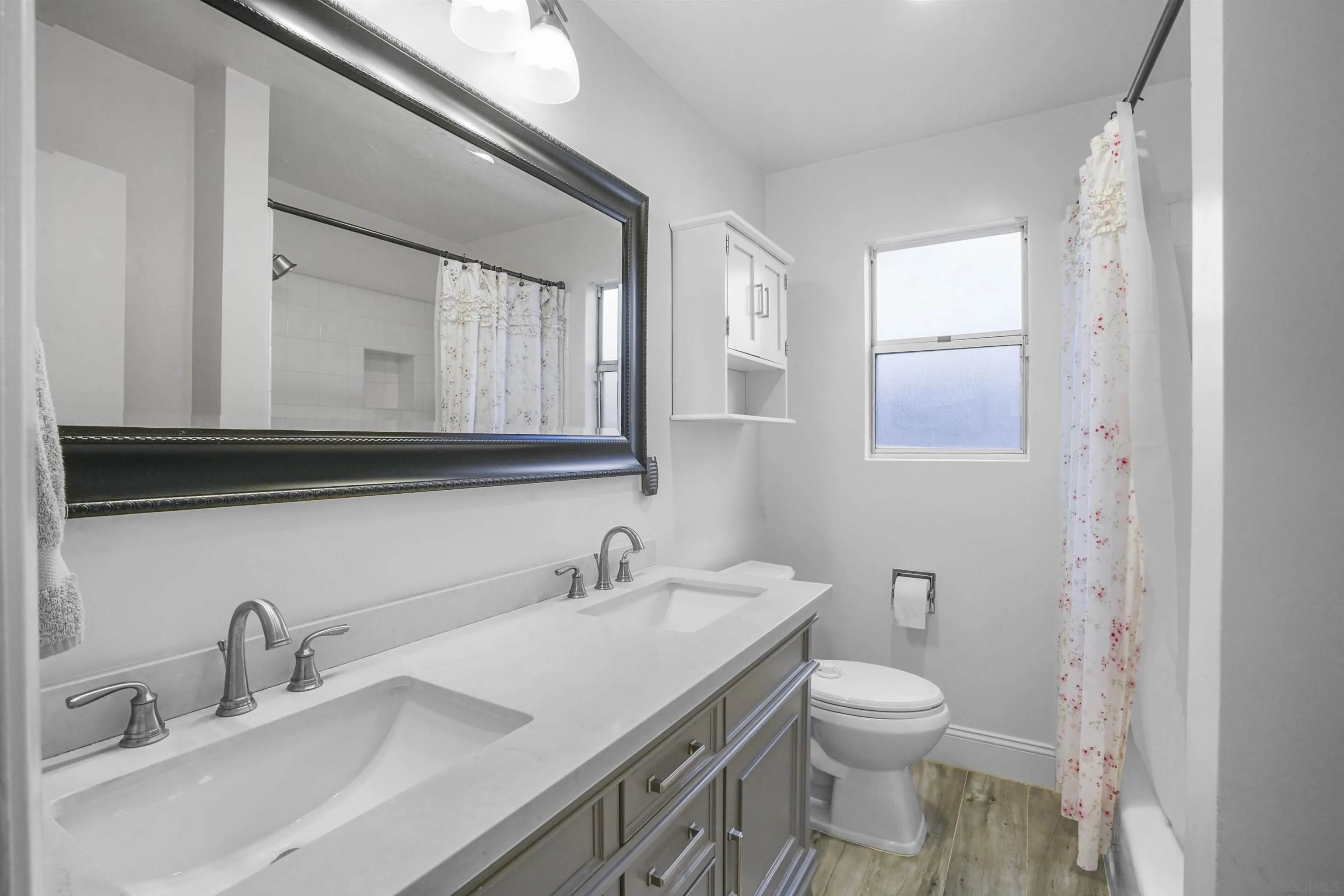 1235 Blue Sky Drive Cardiff, CA 92007 - Photo 19 of 35 a bathroom with a granite countertop toilet sink and mirror