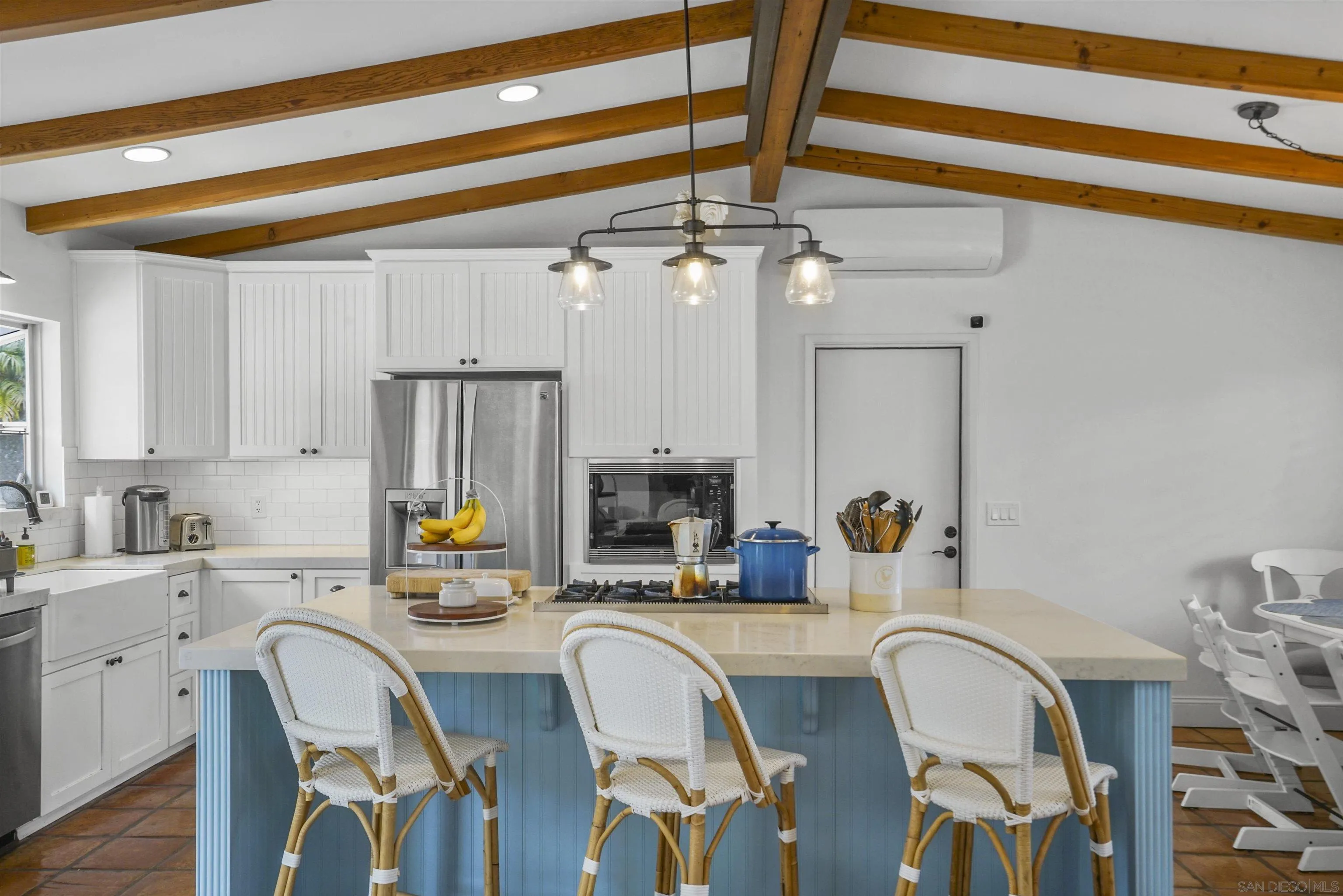 1235 Blue Sky Drive Cardiff, CA 92007 - Photo 10 of 35 a kitchen with stainless steel appliances a table chairs and chandelier