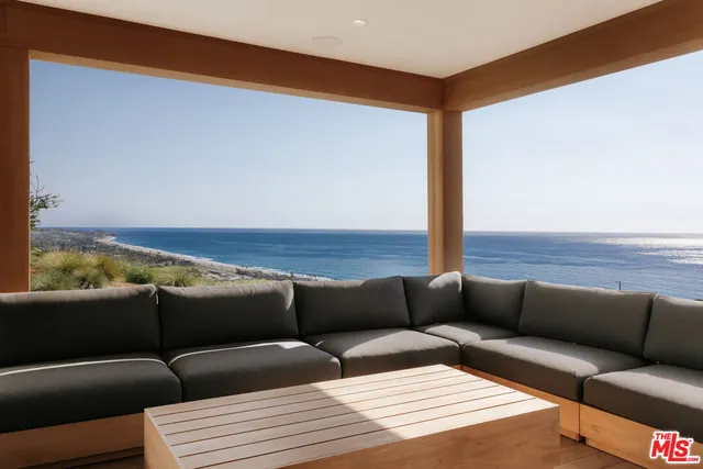 a living room with furniture and a lamp