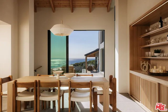 a dining table with chairs and a chandelier