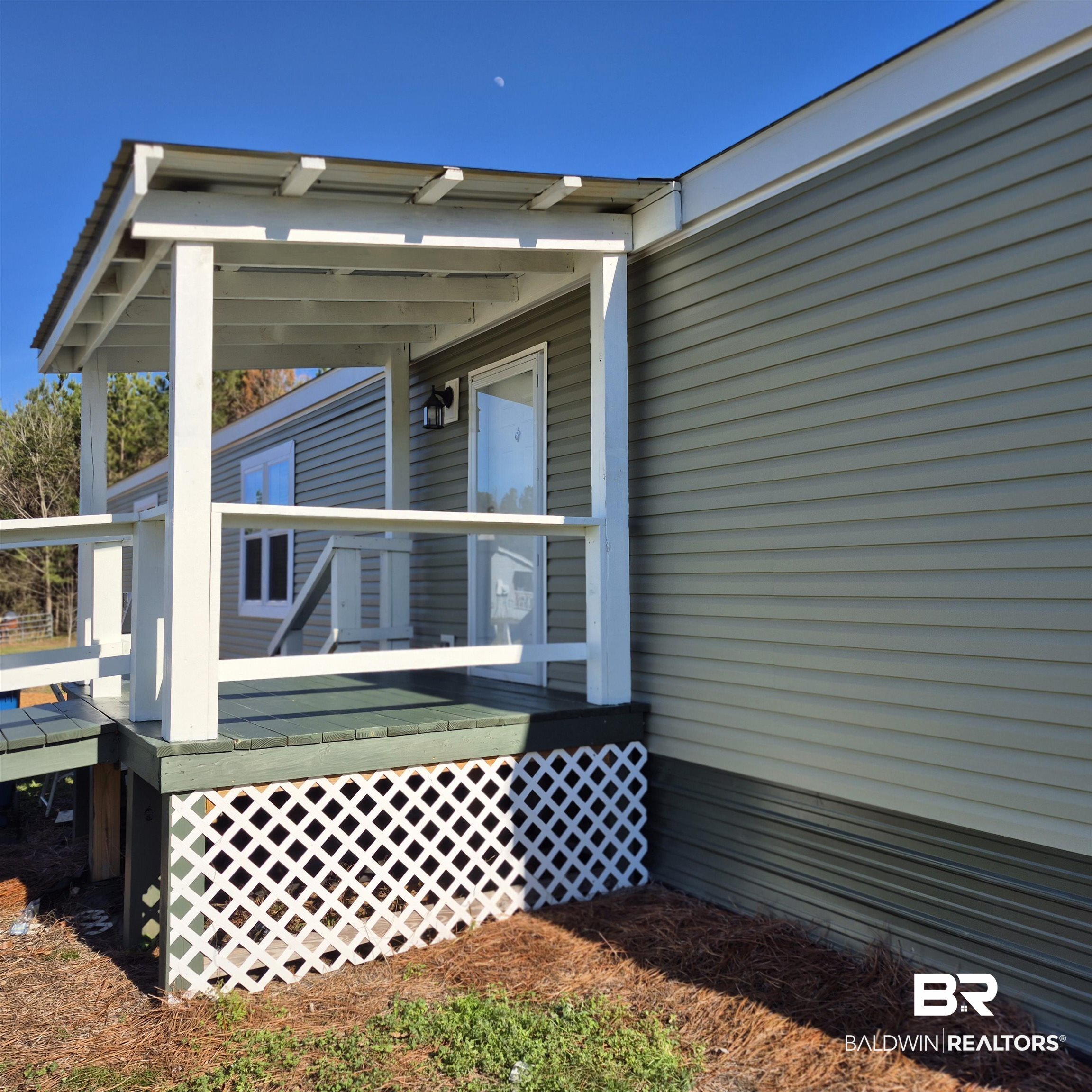 8867 Old Stage Road Repton, AL 36475 - Photo 33 of 37 View of exterior entry featuring a wooden deck