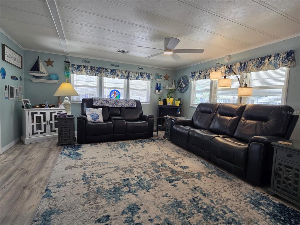 5619 Bayshore Road, Unit 435 Palmetto, FL 34221 - Photo 12 of 56 a living room with furniture and a flat screen tv