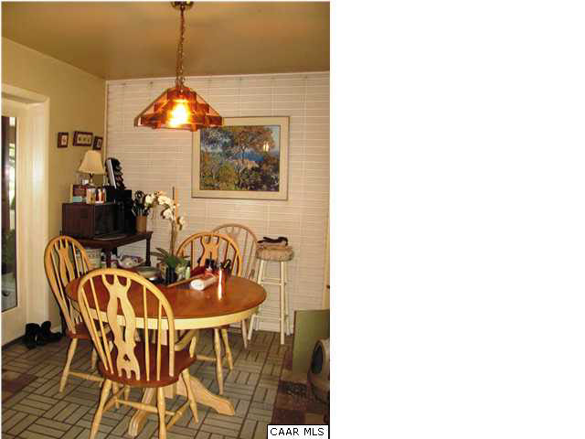 3406 Keswick Road Keswick, VA 22947 - Photo 20 of 28 a dining room with furniture and chandelier