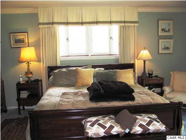 3406 Keswick Road Keswick, VA 22947 - Photo 28 of 28 a bedroom with a bed and a lamp