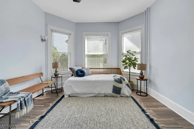 a spacious bedroom with a bed and a table in it