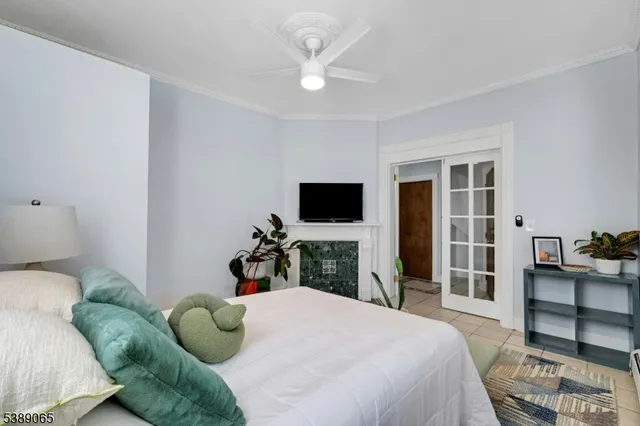 a bedroom with a bed and a flat tv screen on dresser