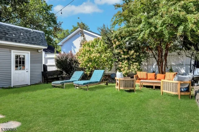 a view of a house with backyard sitting area and garden