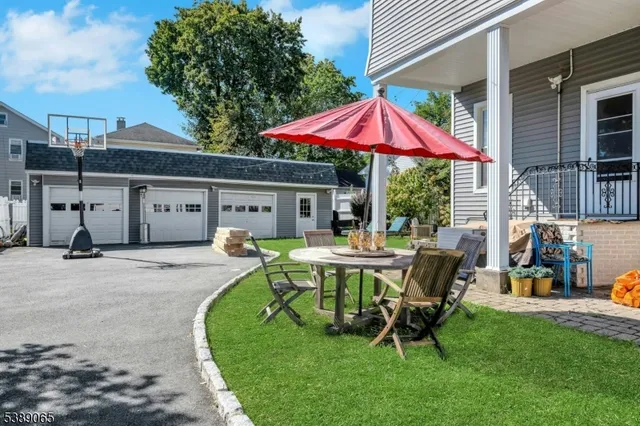 a view of a house with backyard sitting area and furniture