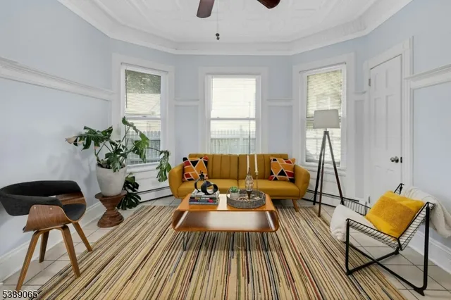 a living room with furniture and a potted plant