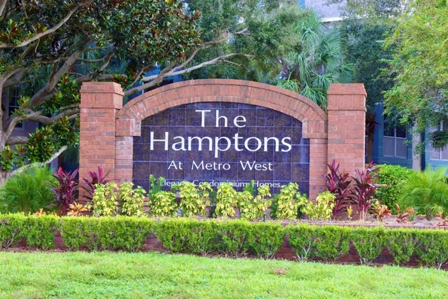 a sign that is sitting in front of flowers