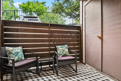 a view of a bench in wooden deck