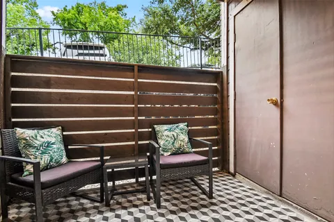 a view of a bench in wooden deck