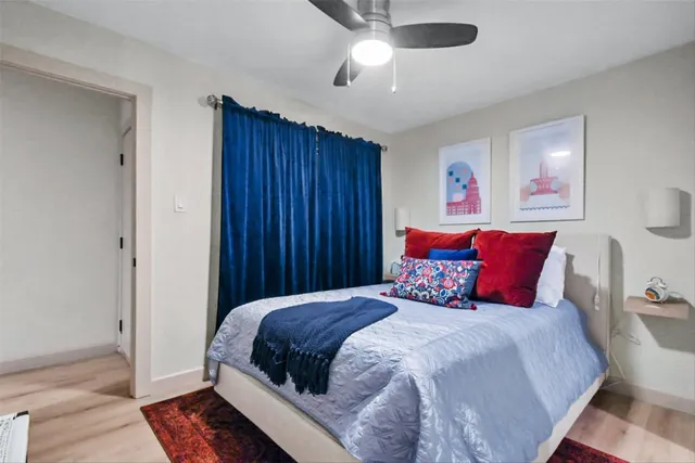 a bedroom with a large bed and a chandelier