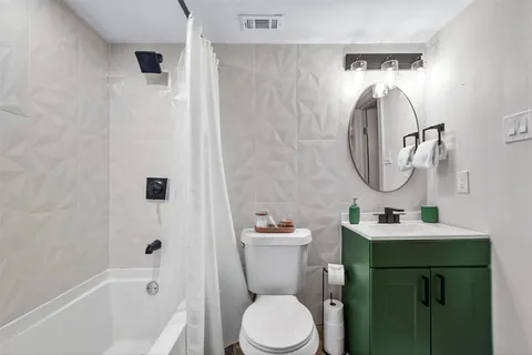 a bathroom with a sink toilet and a mirror