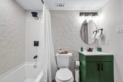 a bathroom with a sink toilet and a mirror