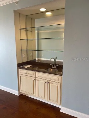 a view of a room with wooden floor and a window