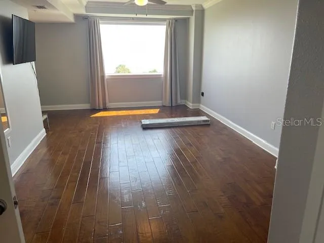 an empty room with wooden floor and closet