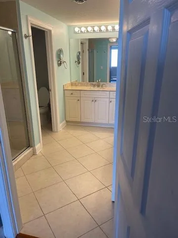 a bathroom with a glass door shower