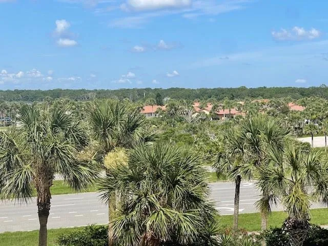 a view of a city with lush green forest