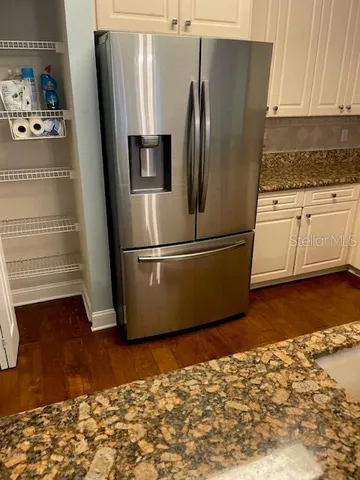a metallic refrigerator freezer sitting in a kitchen