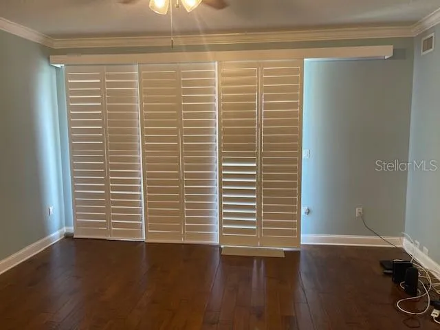 a view of a small space with wooden floor and a window