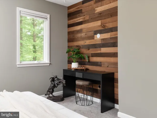 a bathroom with a granite countertop toilet sink and mirror