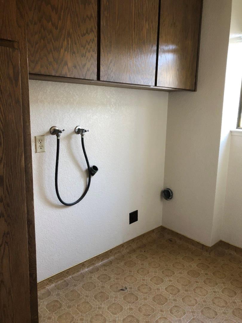 23025 Voss Avenue Cupertino, CA 95014 - Photo 13 of 45 a bathroom with a granite countertop shower and a sink