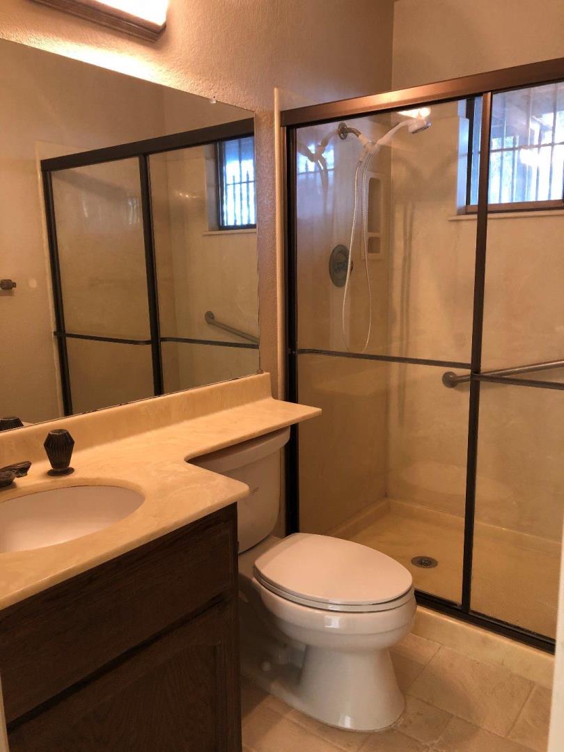 23025 Voss Avenue Cupertino, CA 95014 - Photo 19 of 45 a bathroom with a sink a toilet and shower
