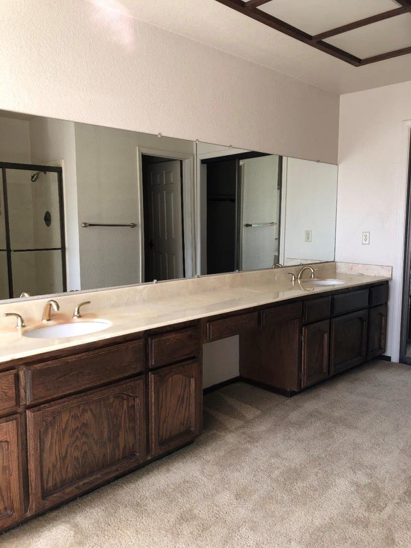 23025 Voss Avenue Cupertino, CA 95014 - Photo 28 of 45 a bathroom with a double vanity sink and a large mirror