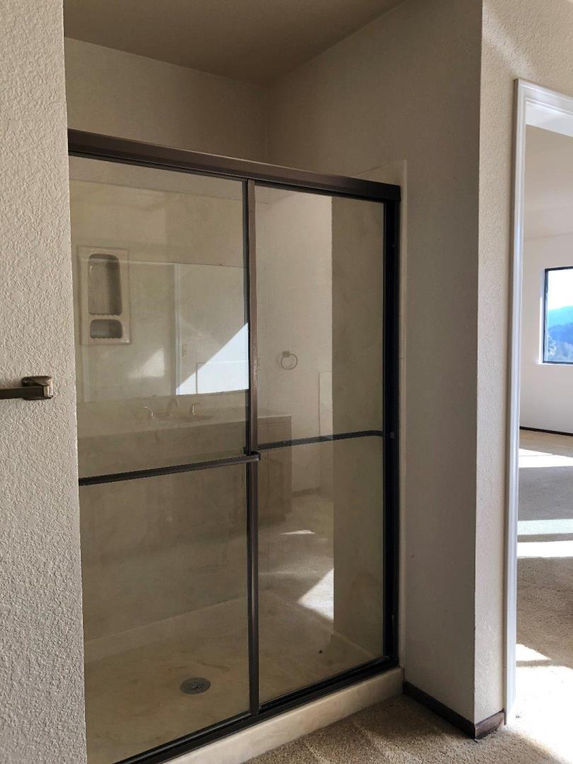 23025 Voss Avenue Cupertino, CA 95014 - Photo 30 of 45 a bathroom with a glass shower door