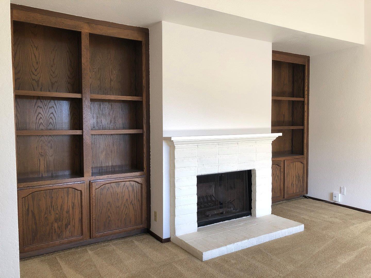 23025 Voss Avenue Cupertino, CA 95014 - Photo 6 of 45 a living room with a fireplace
