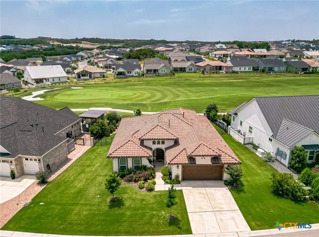 an aerial view of a house with outdoor space and lake view