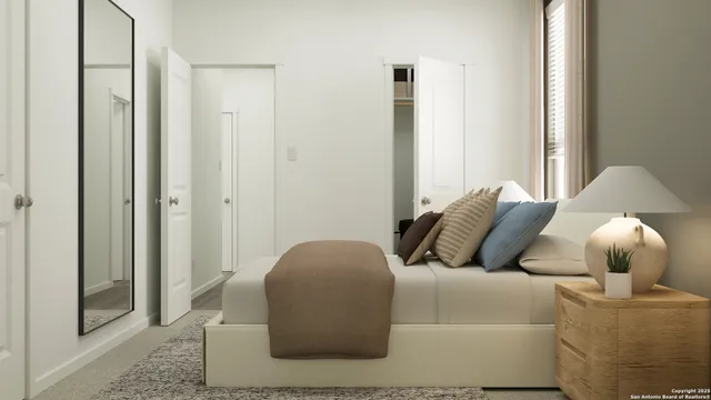 a bedroom with a bed and a painting on the wall