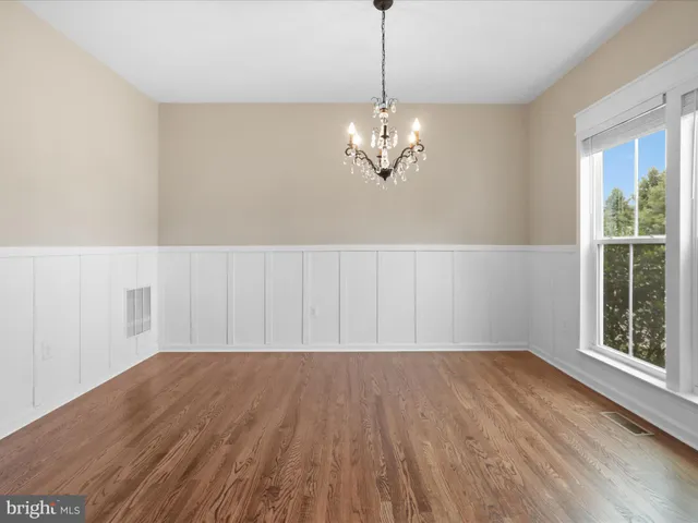 a view of wooden floor and chandelier in a room