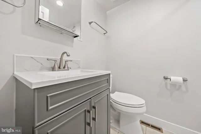 a bathroom with a sink toilet and vanity