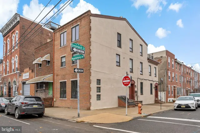 a city street lined with buildings and cars