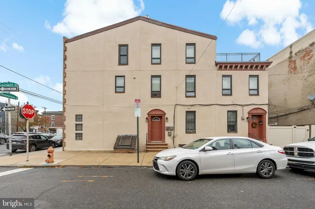a front view of a house with parking space