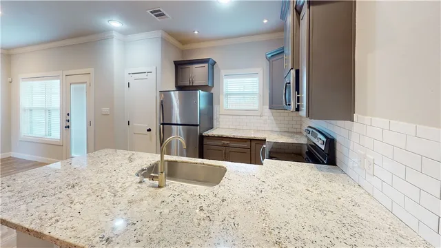 a bathroom with a granite countertop sink a vanity and shower