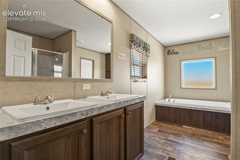 22280 Jones Road Peyton, CO 80831 - Photo 18 of 47 a bathroom with a granite countertop sink mirror and double