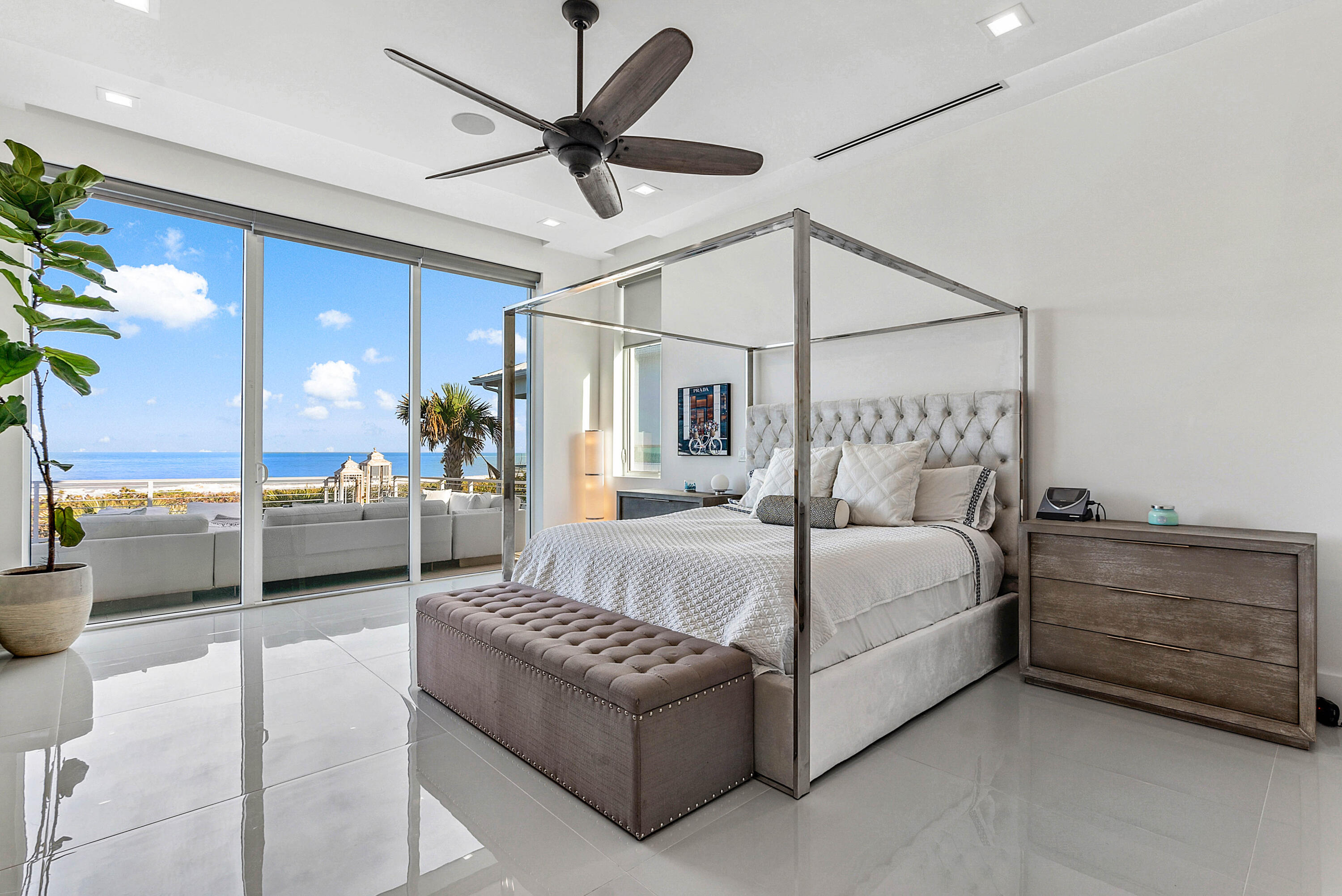 4422 North Hwy A1A Hutchinson Island, FL 34949 - Photo 27 of 86 a bedroom with a bed a couch and a ceiling fan