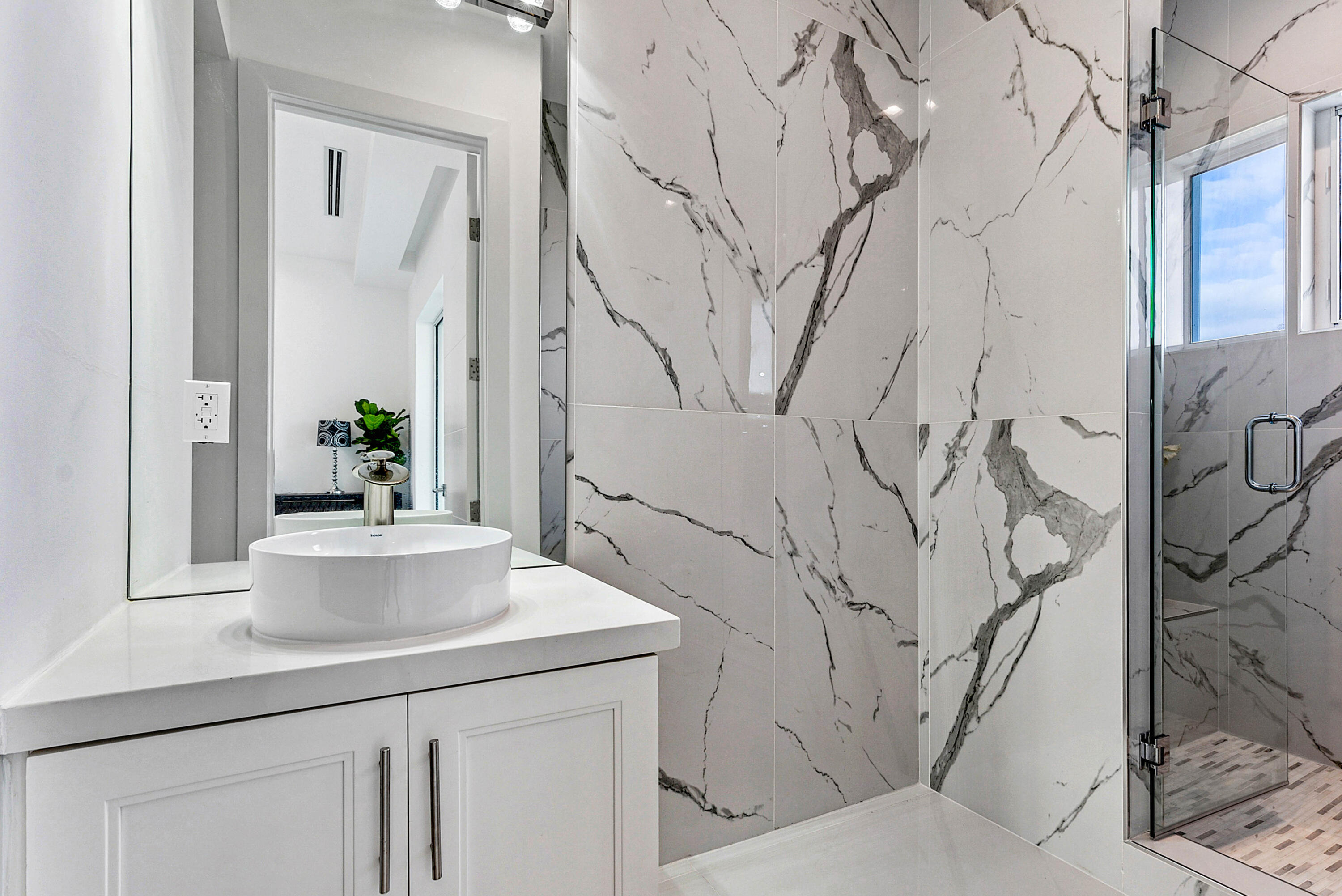 4422 North Hwy A1A Hutchinson Island, FL 34949 - Photo 41 of 86 a bathroom with a sink and mirror with bathtub