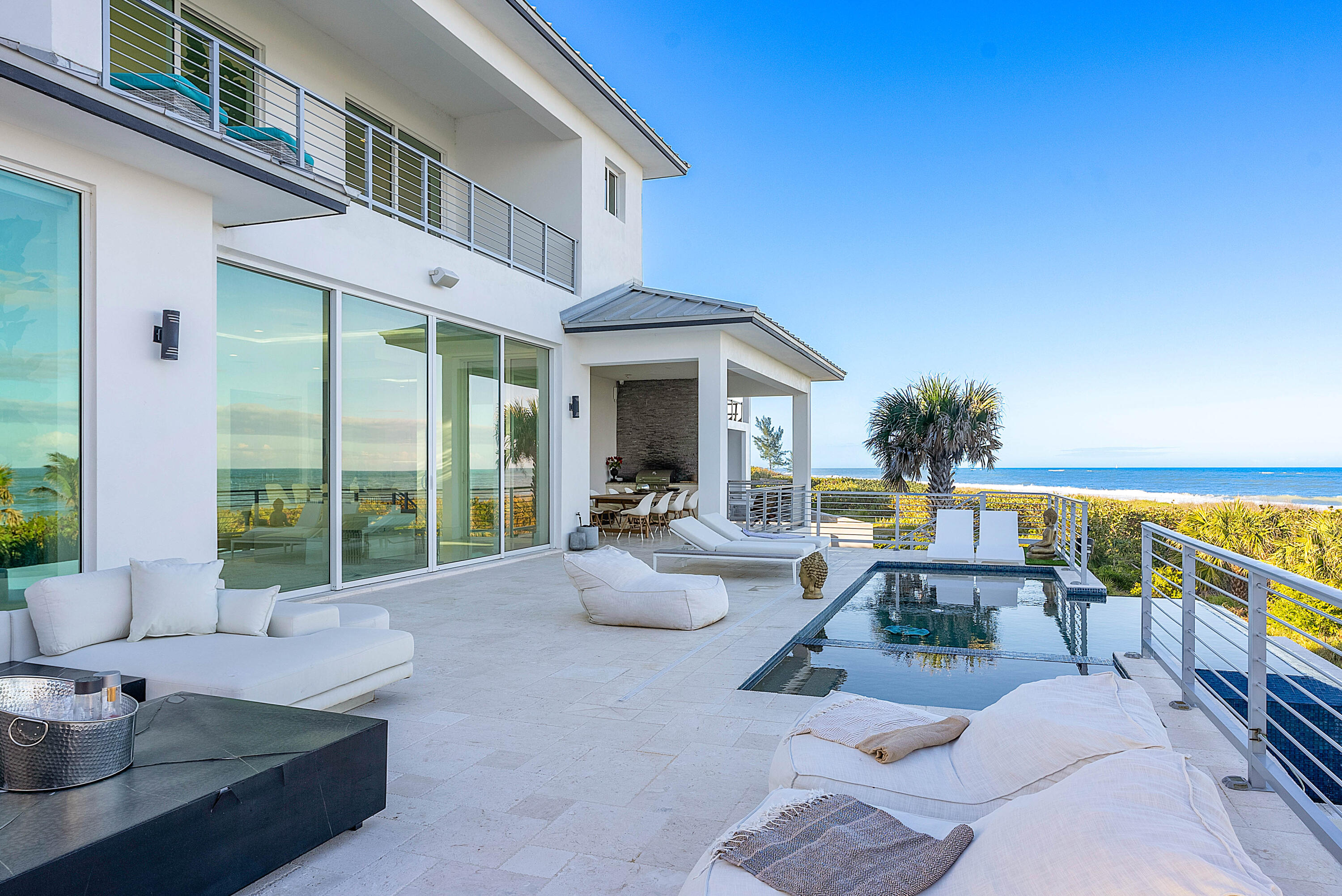 4422 North Hwy A1A Hutchinson Island, FL 34949 - Photo 54 of 86 a front view of a house with outdoor seating