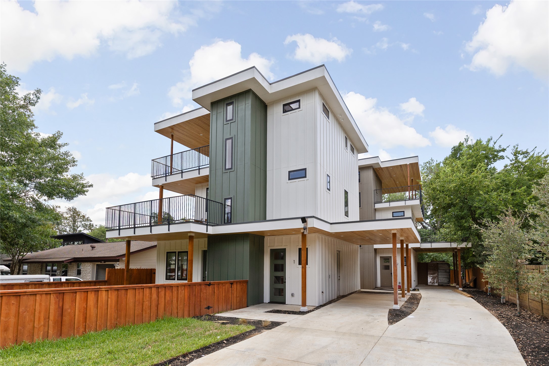 4530 Clawson Road, Unit 1 Austin, TX 78745 - Photo 2 of 24 Back of house featuring driveway, board and batten siding, and a balcony