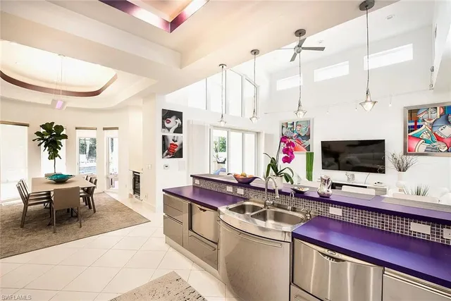 a bathroom with a granite countertop sink a toilet and a mirror